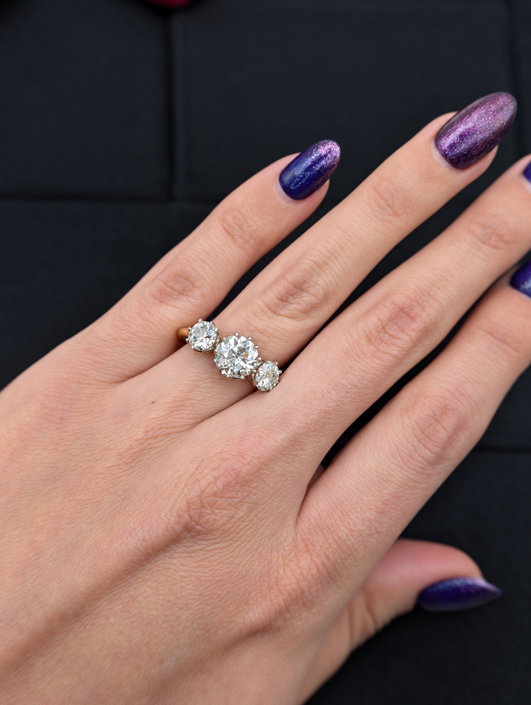 Full hand view of the 3.05 carat three-stone diamond ring