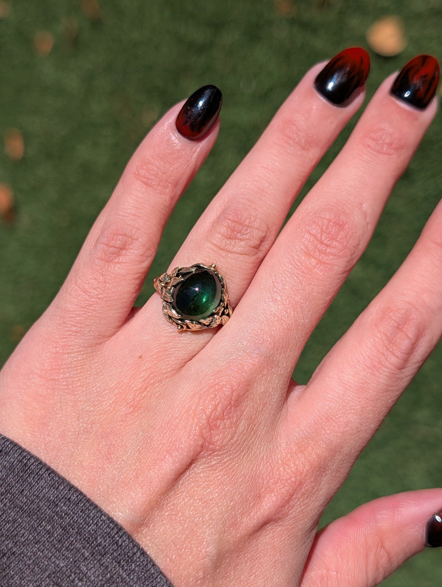 Vintage green tourmaline ring worn on a hand