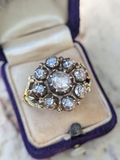 Front view of the vintage Dutch diamond cluster ring in its box