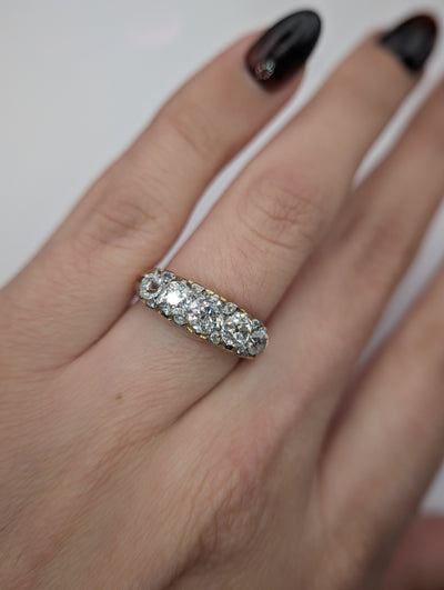 Close view of the antique five diamond ring worn on a hand