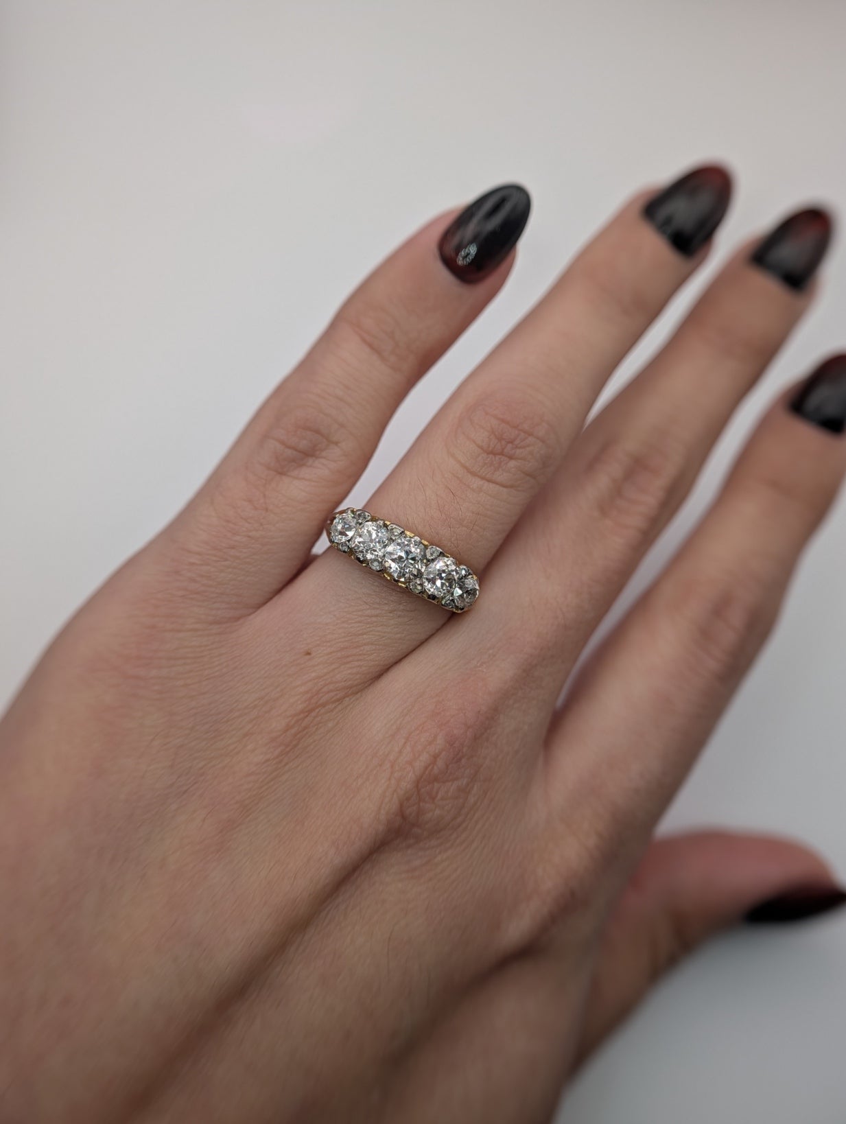 Antique five diamond half hoop ring shown on the hand