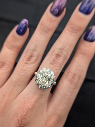 Wide hand view of the cushion diamond halo ring showing its scale when worn