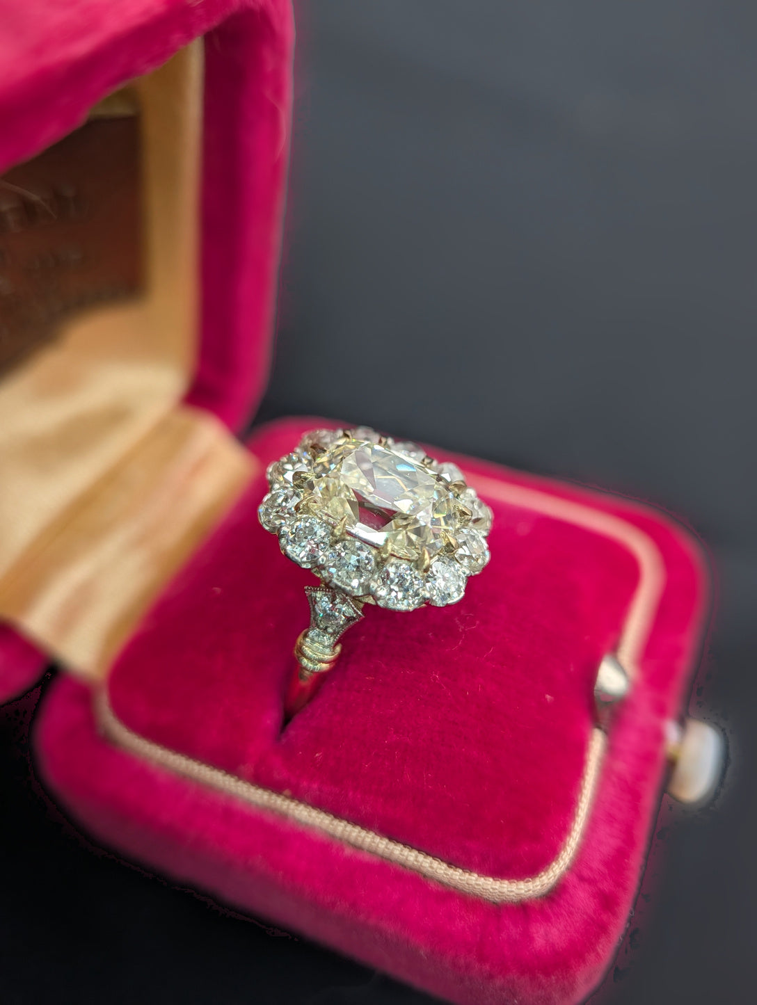 Cushion diamond halo ring in red velvet box, view 6
