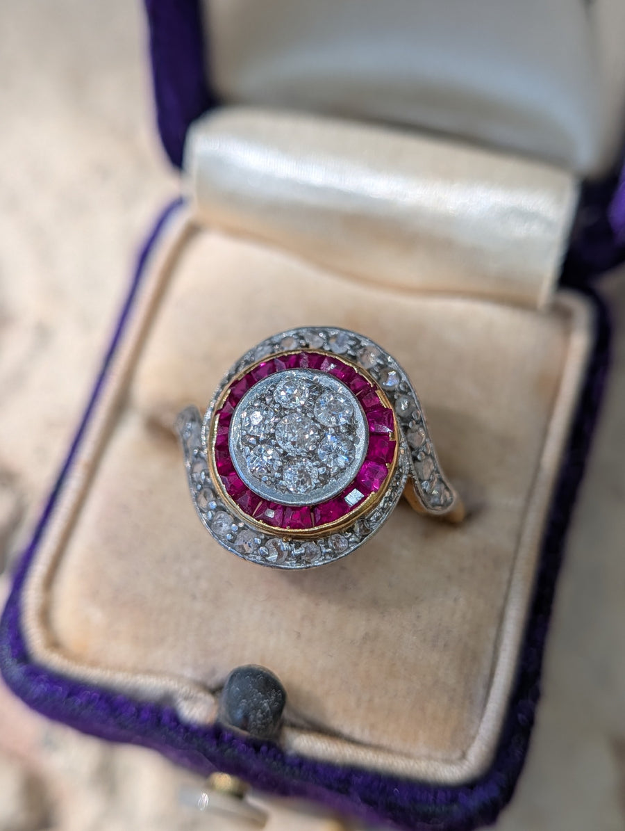 Front view of old European-cut diamond cluster, synthetic ruby border and rose-cut diamond tourbillon ring