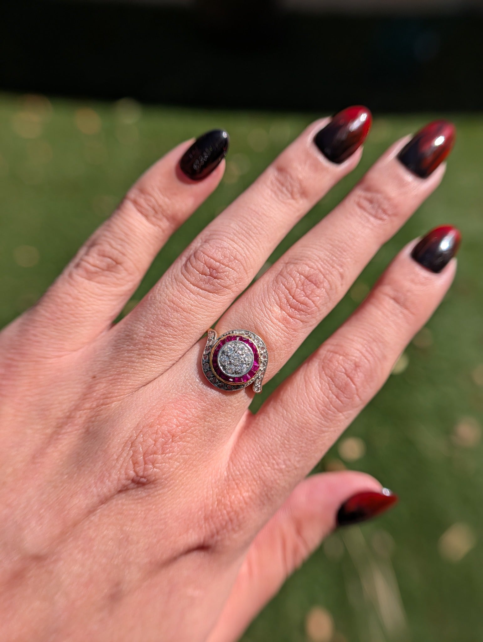 Tourbillon diamond and synthetic ruby ring worn on the hand