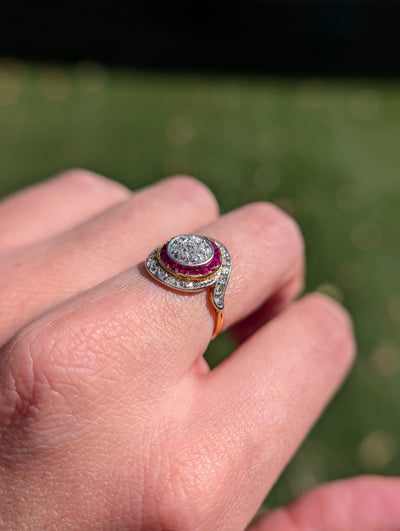 Side view of the low-profile diamond and synthetic ruby cluster ring on the finger