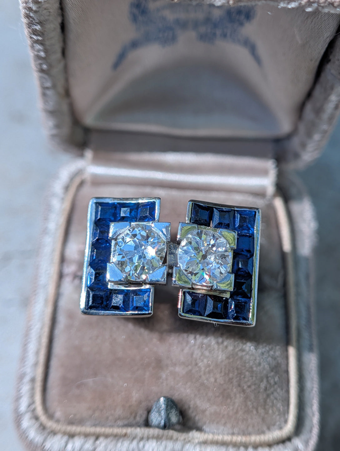 Front view of French 18k white gold tank ring with two old European cut diamonds and synthetic sapphires