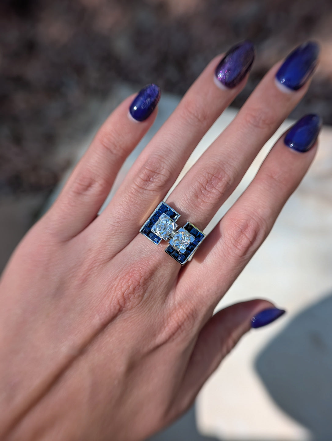 Full hand view of the French diamond and synthetic sapphire tank ring showing scale