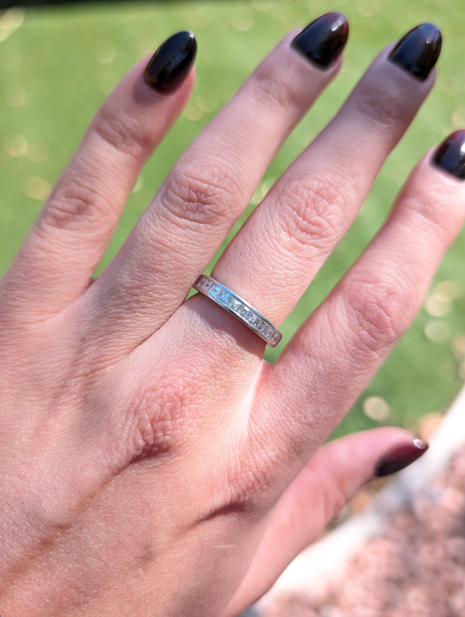 Tiffany & Co. platinum diamond half eternity band worn on the hand
