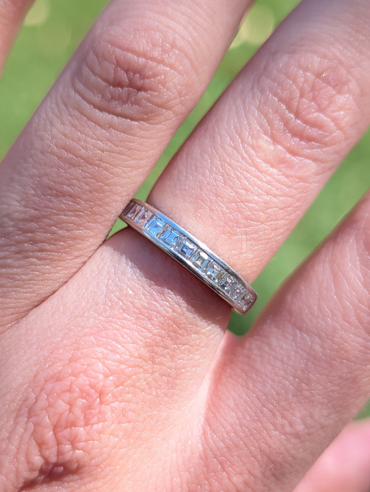 Tiffany & Co. carré-cut diamond half eternity band, close view worn on the hand