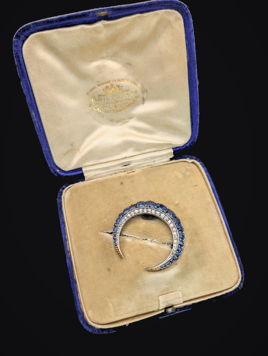 Sapphire crescent brooch in its original Hamilton and Co fitted box against black