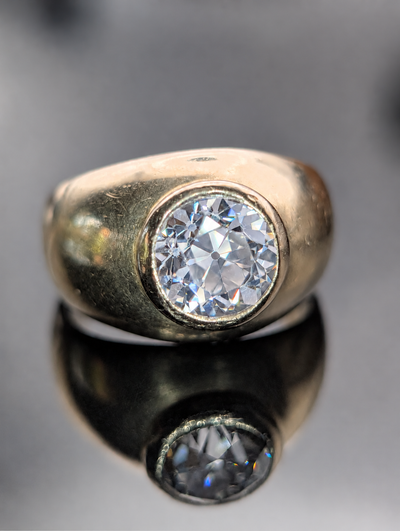 Vintage 18 karat gold bezel ring with old European cut diamond, photographed with its reflection