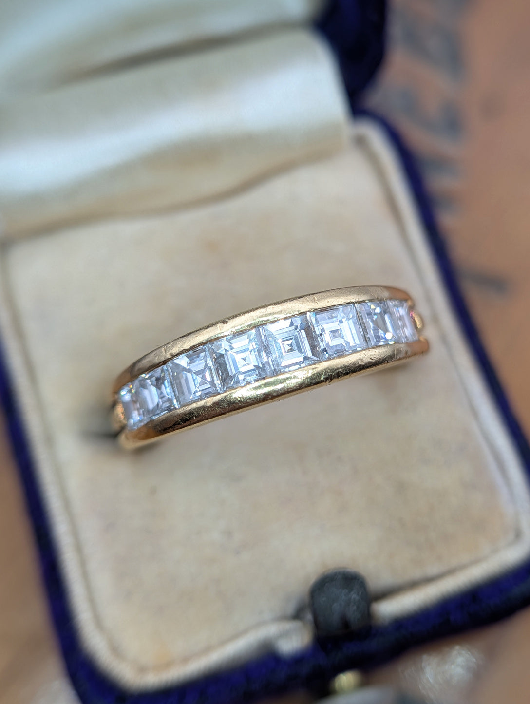 Vintage Boucheron diamond band in 18k yellow gold shown in a ring box