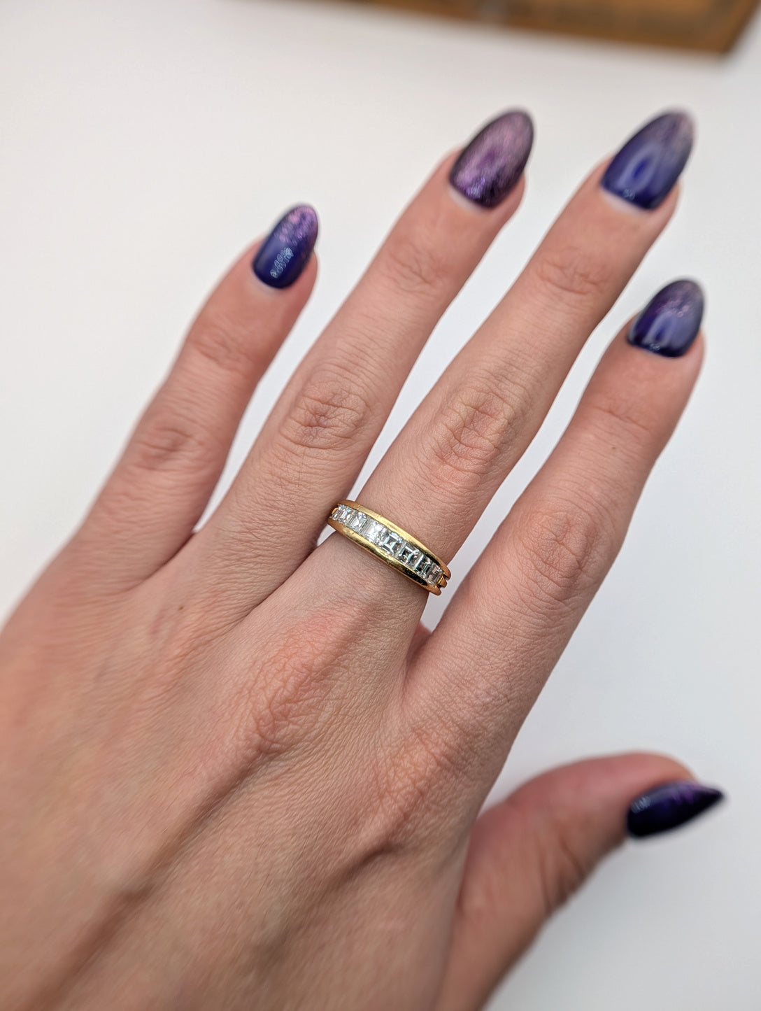 Full hand view of the vintage Boucheron diamond band showing its scale